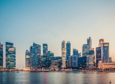 photo-1472148439583-1f4cf81b80e0.jpg Singapore Marina Bay financial district skyline at sunset showcasing modern office buildings and towers that house private equity firms and asset managers