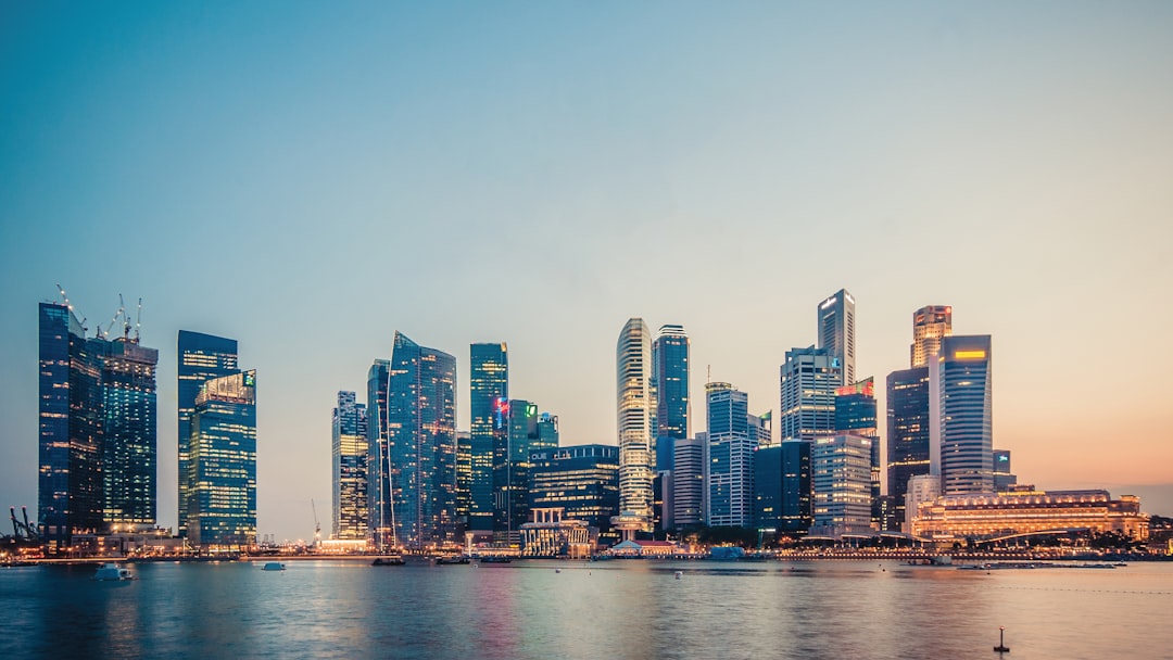 Singapore Marina Bay financial district skyline at sunset showcasing modern office buildings and towers that house private equity firms and asset managers