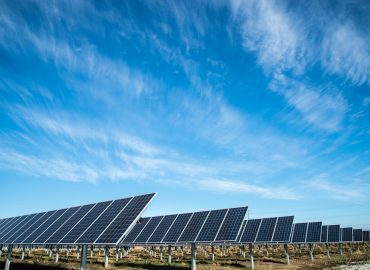 photo-1508514177221-188b1cf16e9d.jpg Large-scale utility solar farm with rows of solar panels under dramatic sky, representing Australia's solar energy investment infrastructure. Photo by Lincoln Electric Systems, Lincoln Nebraska