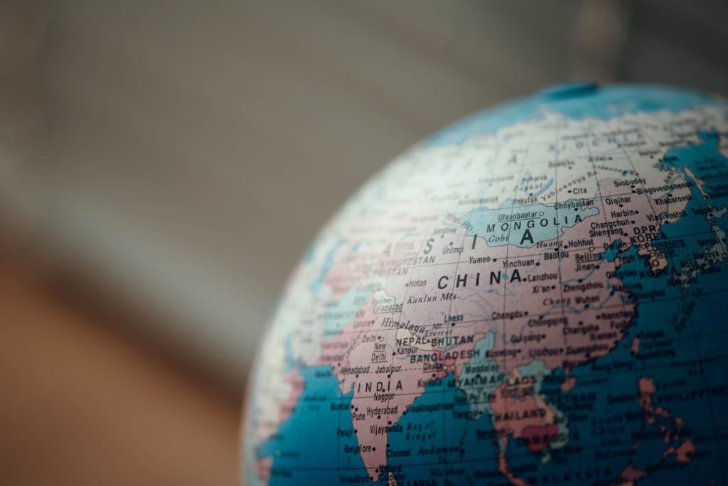 Close-up view of world globe showing Asia-Pacific region including China and Southeast Asia, representing capital flows and investment allocation across APAC markets