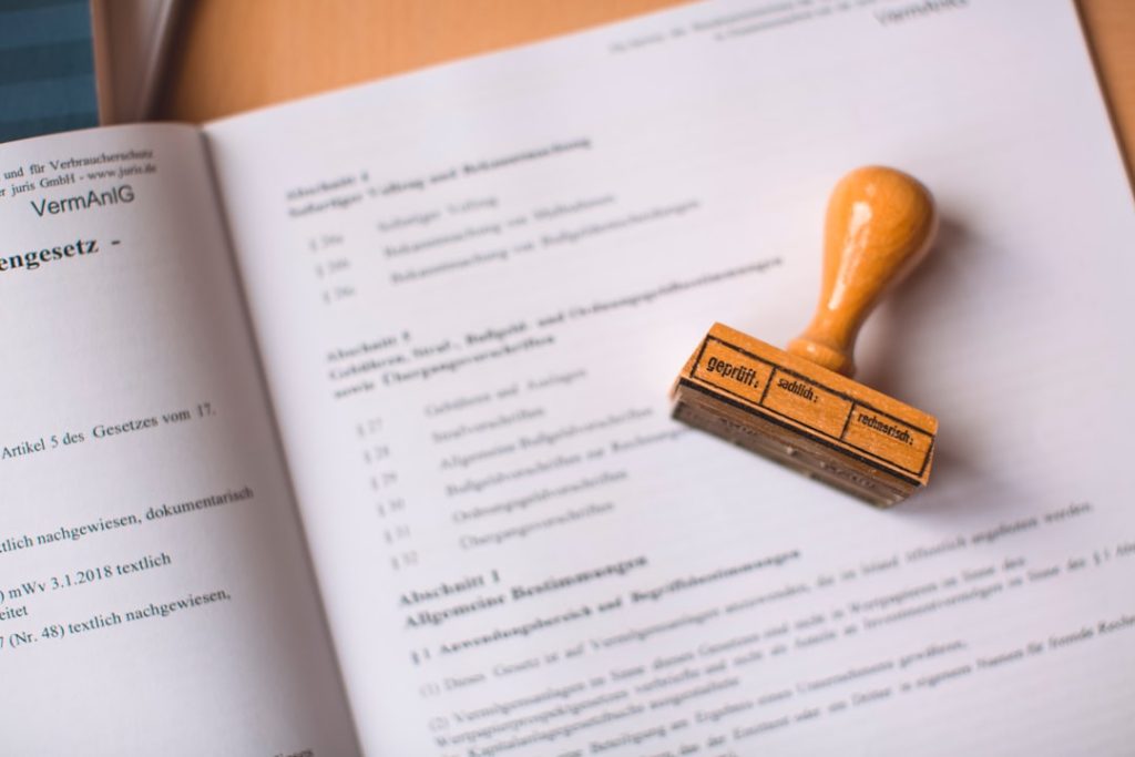 Business documents with approval stamp representing MAS regulatory compliance and VCC framework requirements