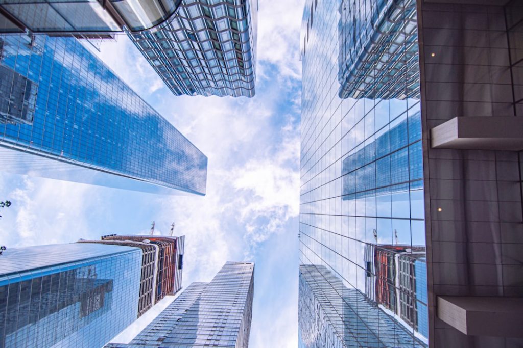 Modern office buildings looking up perspective showing infrastructure financing and investment